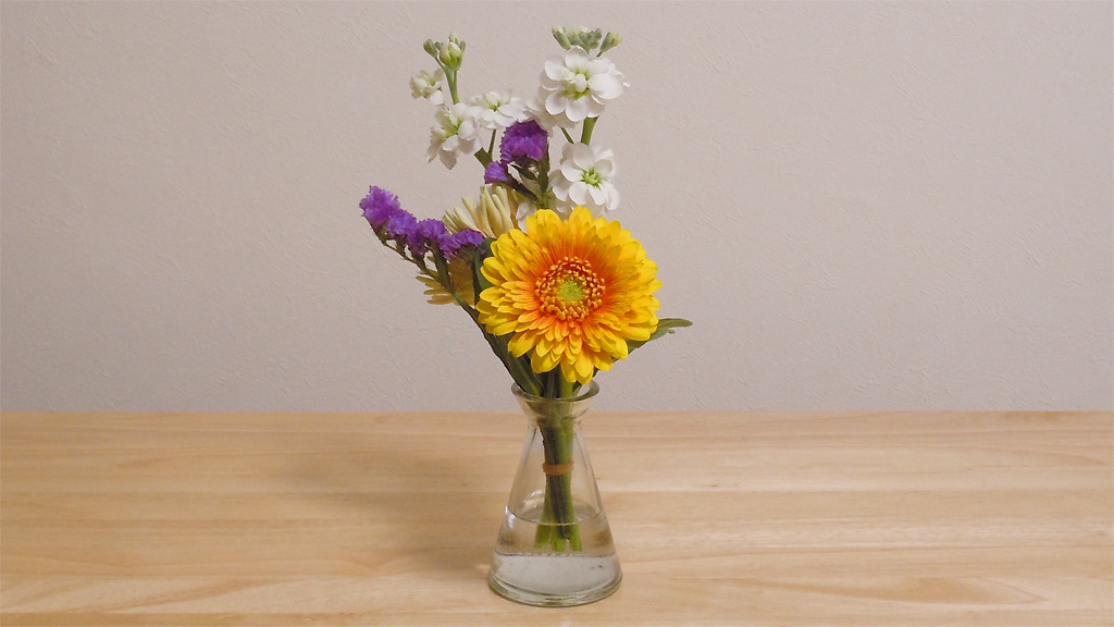 透明ガラスの一輪挿しに黄色いガーベラ、デンファレ等の花を生けました 透明ガラスの一輪挿しに黄色いガーベラ、デンファレ等の花を生けました